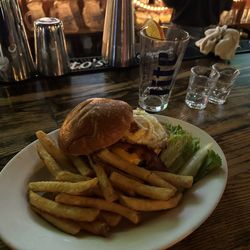 Bradford's Grill & Tavern - HANGOVER BURGER - Angus Beef burger with lettuce, onion & bacon, topped with a hard fried egg, served on a pan toasted brioche roll
