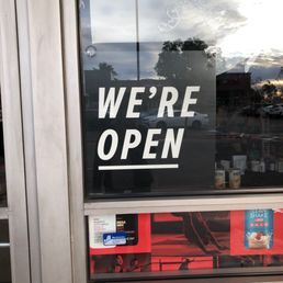 we're open sign in a store window