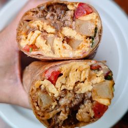 Friends & Family - Pork shoulder in red chili with scrambled eggs, potatoes, cheddar, pico de gallo and hominy in a whole wheat tortilla.