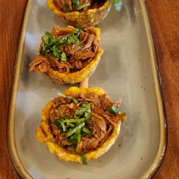 The Grand Cubano - Tostones Rellenos (Fried green plantain cups, stuffed with ropa vieja-shredded beef). - Cuban Near Me - Englewood, New Jersey The Grand Cubano - Tostones Rellenos (Fried green plantain cups, stuffed with ropa vieja-shredded beef). - Cuban Near Me - Englewood, New Jersey