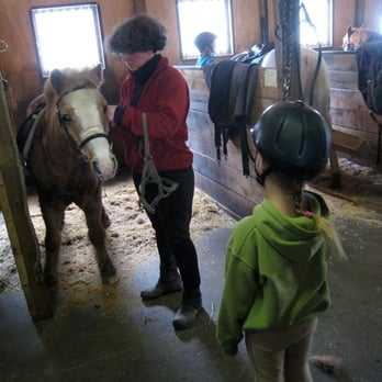 Delaney Stables - Jill helping a student bridle up their favorite school pony for riding. - Horseback Riding Near Me - West Windsor, Vermont