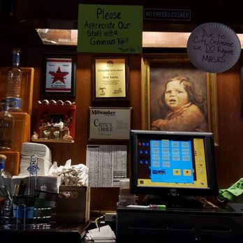 Conejitos Place - a picture of a woman behind a bar - Mexican Near Me - Milwaukee, Wisconsin
