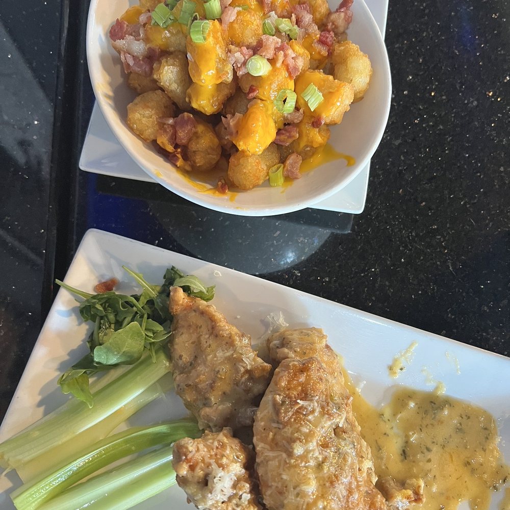 Flashback Retro Arcade + Bar + Grille - Loaded Tots (we got sour cream on the side) and garlic Parmesan chicken tenders. - Bars Near Me - Hyannis, Massachusetts