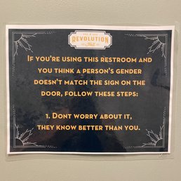 A sign in the women's restroom A sign in the women's restroom