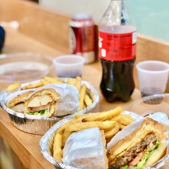 Food Junction - a sandwich and french fries on a table - Pizza Near Me - Jackson Heights, New York Food Junction - a sandwich and french fries on a table - Pizza Near Me - Jackson Heights, New York