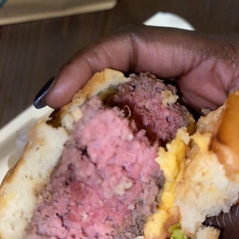 Half Moon Bar & Grill - a hand holding a hamburger - Bars Near Me - New Orleans, Louisiana Half Moon Bar & Grill - a hand holding a hamburger - Bars Near Me - New Orleans, Louisiana