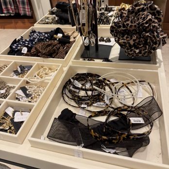 J.Crew - Jewelry, headbands, and accessories are arranged on a table in a retail store, including necklaces, headbands, and scarves. - Men's Clothing Near Me - Austin, Texas