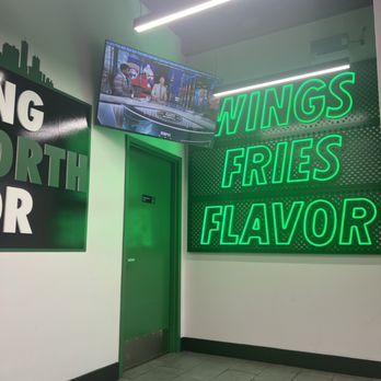 Wingstop - They have some benches to watch tv while waiting for your wings. - Chicken Wings Near Me - Lake Worth, Texas