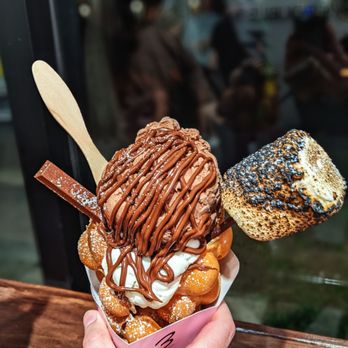 Double Three - Double chocolate and vanilla in an original bubble waffle cone topped with a toasted marshmallow, KitKat, and a drizzle of Nutella sauce - Ice Cream & Frozen Yogurt Near Me - Kailua, Hawaii Double Three - Double chocolate and vanilla in an original bubble waffle cone topped with a toasted marshmallow, KitKat, and a drizzle of Nutella sauce - Ice Cream & Frozen Yogurt Near Me - Kailua, Hawaii