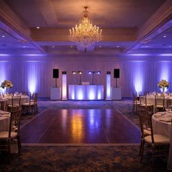 Fan Mob Entertainment - Elegant wedding reception setup with professional DJ lighting and a clean, open dance floor.