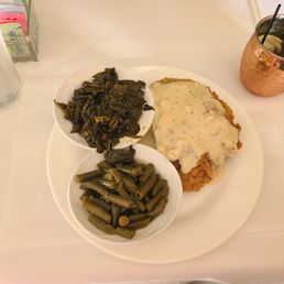 Country fried steak with a side of green beans and a side of collards. Country fried steak with a side of green beans and a side of collards.