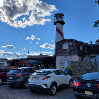 Curtin's Wharf Restaurant - cars parked in front of a lighthouse - American Near Me - Burlington, New Jersey
