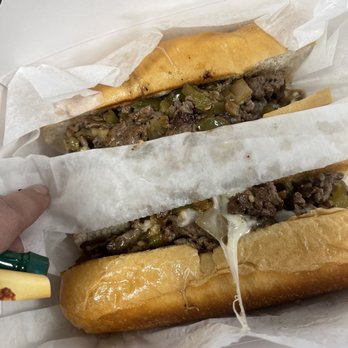 Phillyman Cheesesteak - a hand holding a sandwich - Cheesesteaks Near Me - Nashville, Tennessee Phillyman Cheesesteak - a hand holding a sandwich - Cheesesteaks Near Me - Nashville, Tennessee