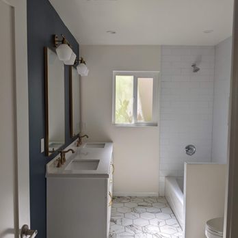 Creative Innovation Developers - a white bathroom with a blue accent - General Contractors Near Me - Burbank, California
