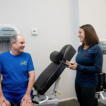 The Perfect Workout - Client talking to trainer about their results - Gyms Near Me - Arlington, Texas The Perfect Workout - Client talking to trainer about their results - Gyms Near Me - Arlington, Texas