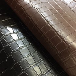 Frogjelly Leather - Whole hides of black and brown crocodile embossed cowhides.