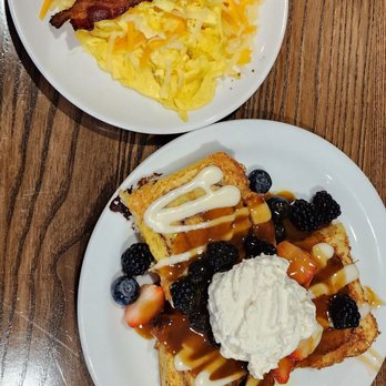 Another Broken Egg Cafe - Cinnamon roll like pancakes smothered in assorted berries. A side of scrambled eggs with cheese and bacon. - American Near Me - Williamsburg, Virginia Another Broken Egg Cafe - Cinnamon roll like pancakes smothered in assorted berries. A side of scrambled eggs with cheese and bacon. - American Near Me - Williamsburg, Virginia