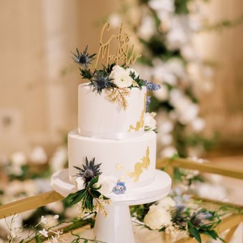 Maria's Dream Cakes - a white wedding cake decorated with blue and white flowers - Desserts Near Me Maria's Dream Cakes - a white wedding cake decorated with blue and white flowers - Desserts Near Me