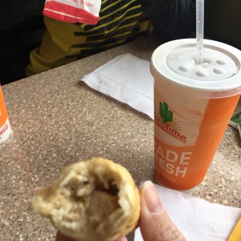 Taco Time - a hand holding a half eaten pastry - Mexican Near Me - Roseburg, Oregon