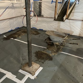 Quality 1st Basement Systems - After rock, barrier vapor layer the pouring began. - Waterproofing Near Me - Cliffwood, New Jersey