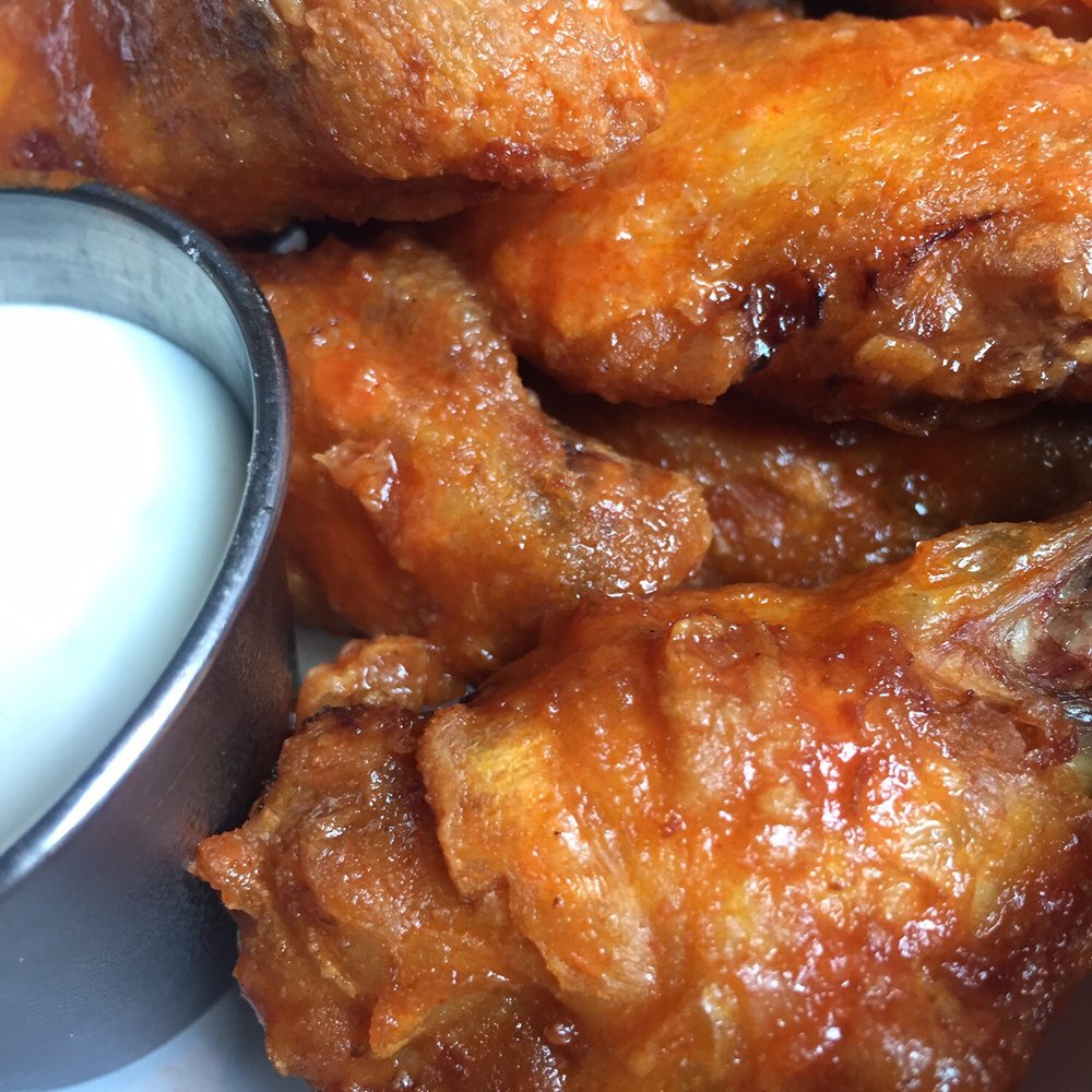 Sriracha Wings ($12) w/ ranch dipping ($1.50). Really it's not even hot or taste like sriracha. Sriracha Wings ($12) w/ ranch dipping ($1.50). Really it's not even hot or taste like sriracha.