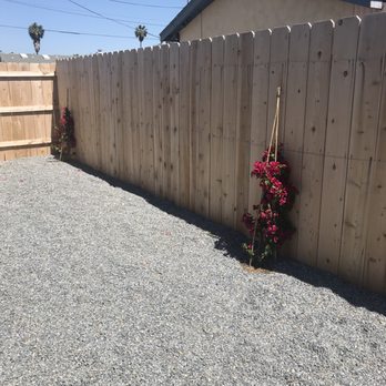 Four Seasons Landscape - Bougainvilleas in San Diego red. They are positioned on the side of the house, each facing a bedroom window. All work completed by FSL! - Landscaping Near Me