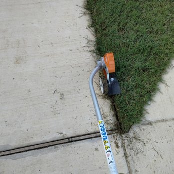 Turf Tamers - a lawn mower on the sidewalk - Lawn Services Near Me Turf Tamers - a lawn mower on the sidewalk - Lawn Services Near Me