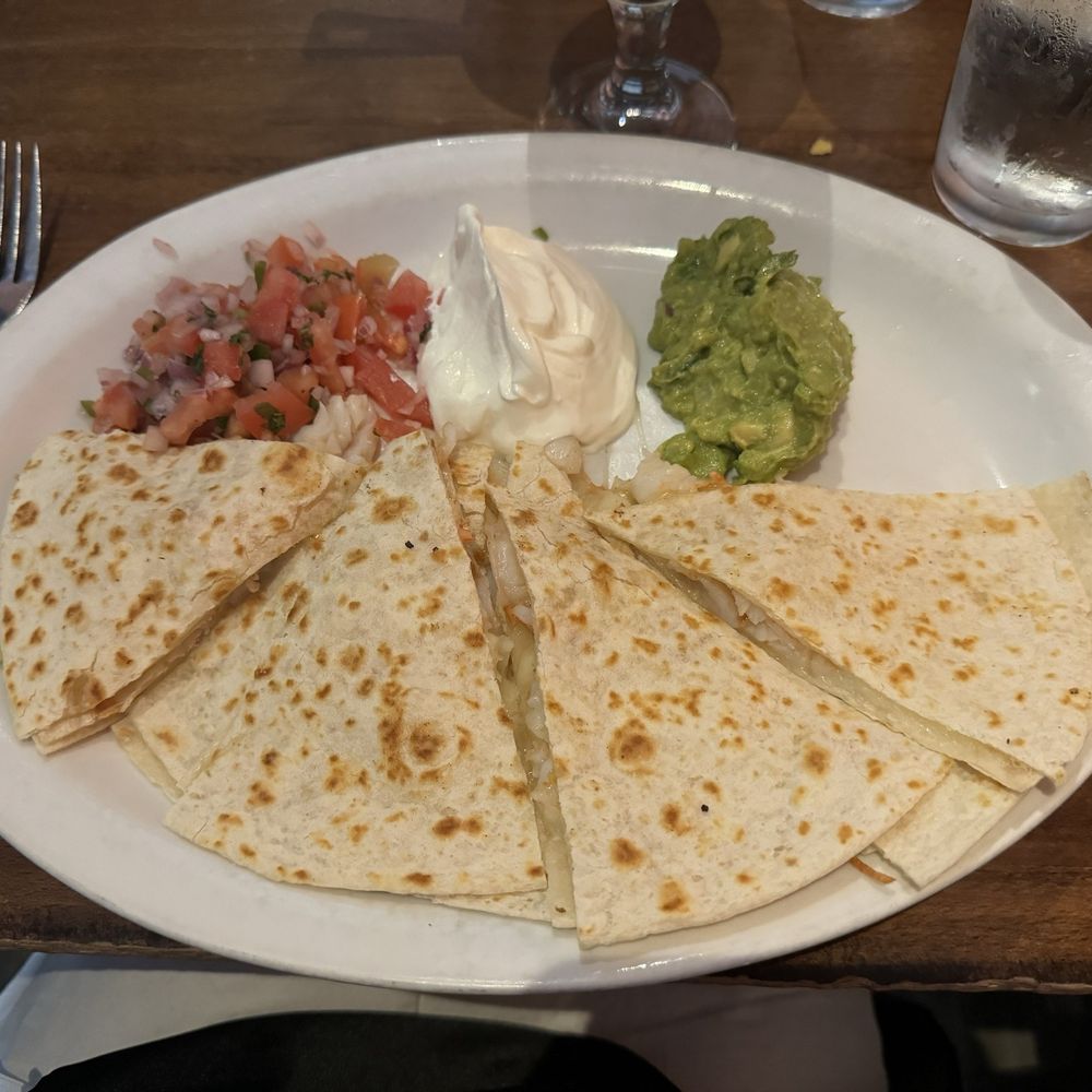 Shrimp quesadillas with guacamole, sour cream and pico de gallo. Shrimp quesadillas with guacamole, sour cream and pico de gallo.