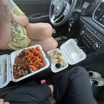 China Gray - a woman sitting in the passenger seat of a car with a tray of food in her lap - Chinese Near Me - Gray, Maine