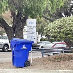 City of San Diego Environmental Services Department - Outside: recycling bin attached to parking lot entrance signage