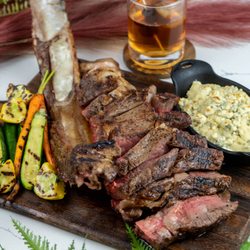 Toast Kitchen & Bar - Tomahawk steak 40oz bone-in ribeye served with blue cheese mash potatoes and seasonal vegetables.
