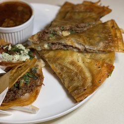 Gringo’s Tacos & Birria - Birria taco, Al Pastor taco, Quesabirria, and Consommé.