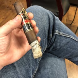 Schwab's Pipes N Stuff - Chubby white dude smoking a Perdomo Vintage 12yr in the middle of the day with legs crossed