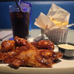 Bone in wings, fries, and a soda.