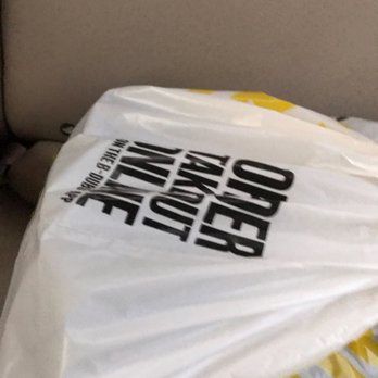 Buffalo Wild Wings - a bag of food on the back of a car - Chicken Wings Near Me - Cedar Rapids, Iowa