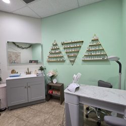 Salon Fusion - Nail room, wall of colors and manicure station.