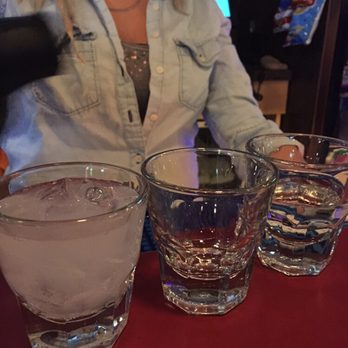 Beef's - a woman sitting at a bar with four glasses of water - Burgers Near Me - Horseheads, New York