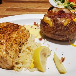 Salmon, loaded potato and side salad. Salmon, loaded potato and side salad.