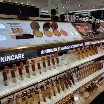 SEPHORA - Sephora in Elmhurst, NY, features a display of makeup products such as foundations, powders, and concealers, with branding for Charlotte Tilbury and Airbrush Flawless Collection. - Skin Care Near Me - Elmhurst, New York