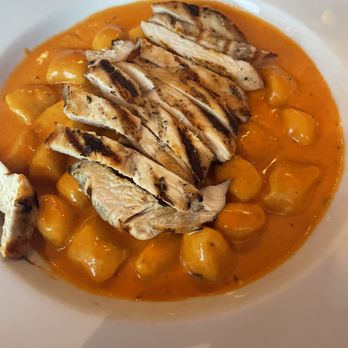 Alfredo's Italian Restaurant - Gnocchi is creamy tomatoes sauce topped with grilled chicken breast. My granddaughter enjoyed her spaghetti bolognese. - Italian Near Me - Petaluma, California