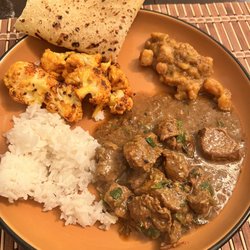 RB’s Tasty Treats And Delicious Dinners - Lamb curry, rice, potatoes, cauliflower, and roti