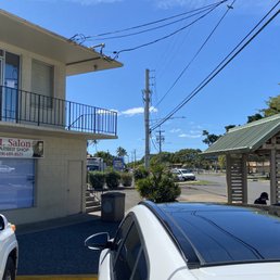 View from two diagonal parking spots in front of salon.