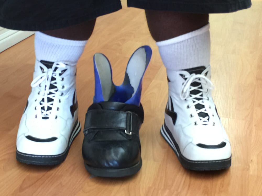 Old Man Looking Shoe With Brace For Club Feet Traded In For Young