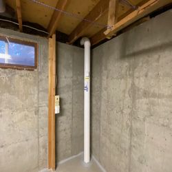 Protect Environmental - Neat, clean radon mitigation system installation in just the right place.