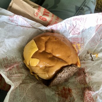 McDonald's - a cheeseburger wrapped in paper - Fast Food Near Me - Delta, British Columbia McDonald's - a cheeseburger wrapped in paper - Fast Food Near Me - Delta, British Columbia