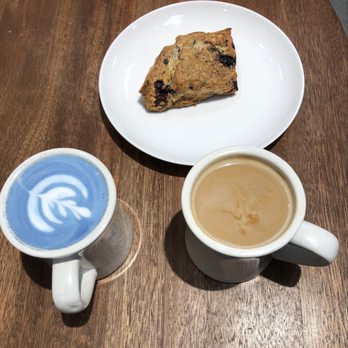 Remi Flower & Coffee - Butterfly Pea Latte (left), their popular Blueberry Scone (center), Americano (right) - Coffee & Tea Near Me - New York, New York Remi Flower & Coffee - Butterfly Pea Latte (left), their popular Blueberry Scone (center), Americano (right) - Coffee & Tea Near Me - New York, New York