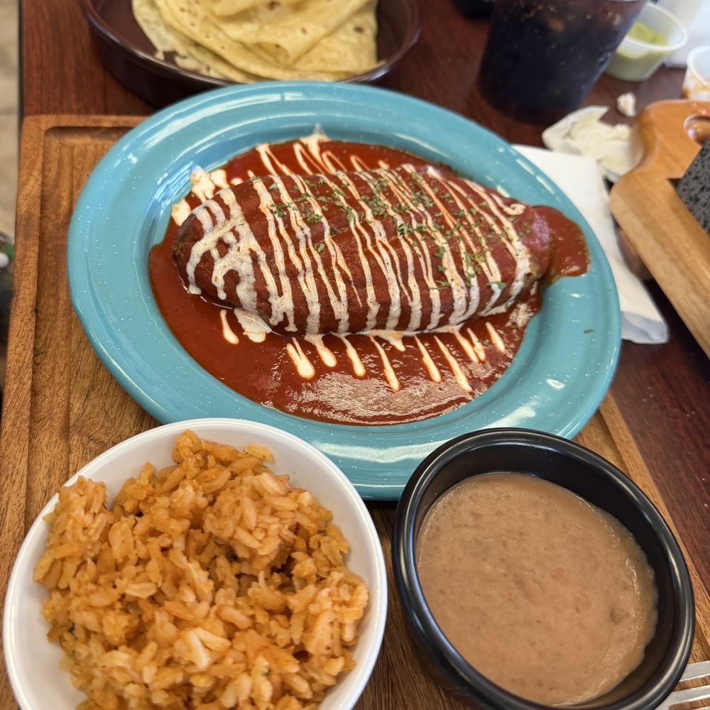 Chile Relleno meal featuring Chile Relleno, beans, rice, and flour tortillas.