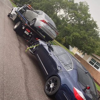 Breadwynners - a car being towed by a tow truck - Towing Near Me Breadwynners - a car being towed by a tow truck - Towing Near Me