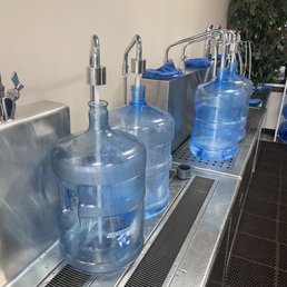 a row of water bottles on a conveyor belt a row of water bottles on a conveyor belt