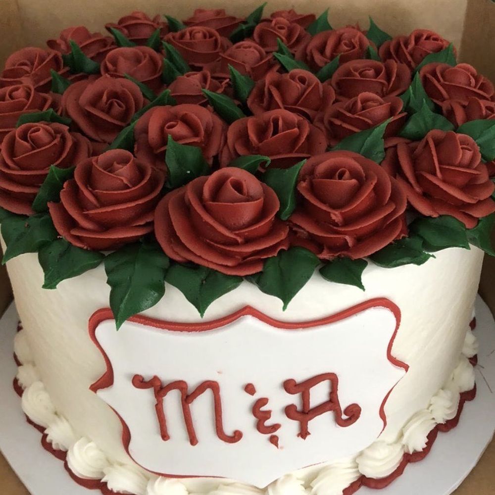 a cake decorated with red roses a cake decorated with red roses